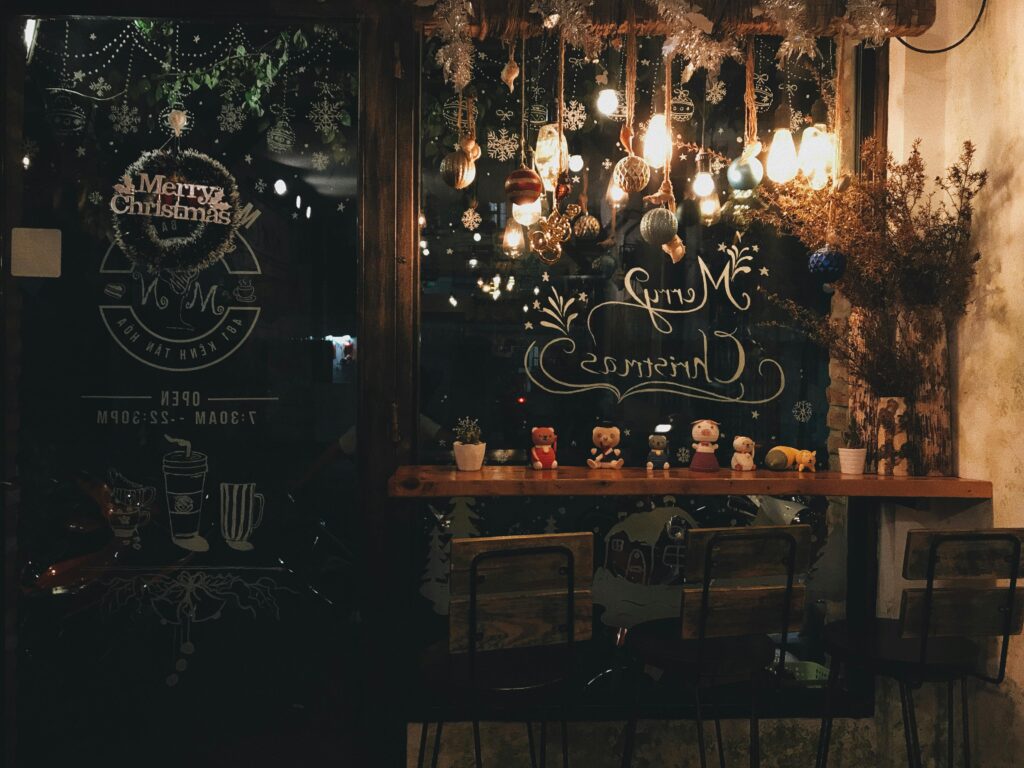 Warm and festive cafe interior with elegant Christmas decorations and inviting lighting.